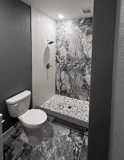 Close-up of bathroom tile detail and grout lines from a Mannis Home Enhancement remodeling project.