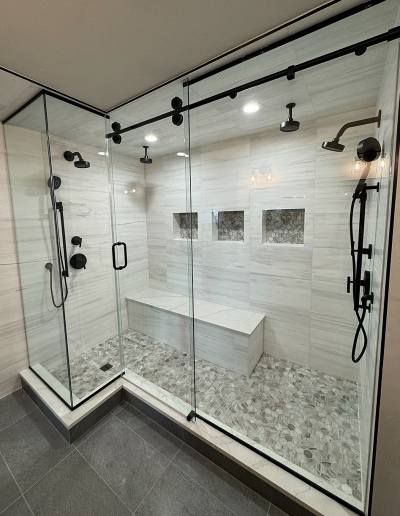 Modern bathroom remodel with walk-in shower, glass door, and tile walls in a Boulder, Colorado home.