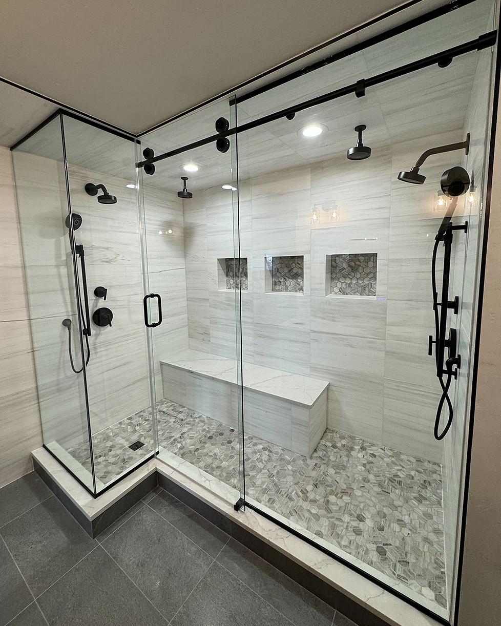 Modern bathroom remodel with walk-in shower, glass door, and tile walls in a Boulder, Colorado home.