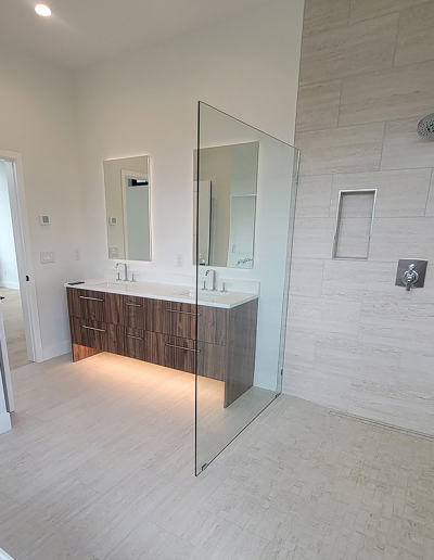 Bright bathroom featuring white subway tile, black fixtures, and a custom shower niche.