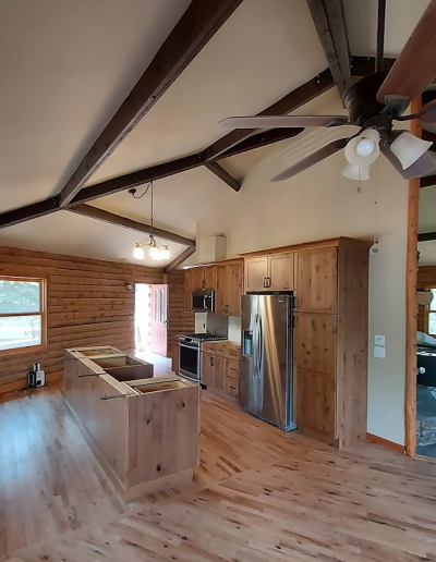 Warm wood cabinets, under-cabinet lighting, and updated flooring in a full kitchen renovation.